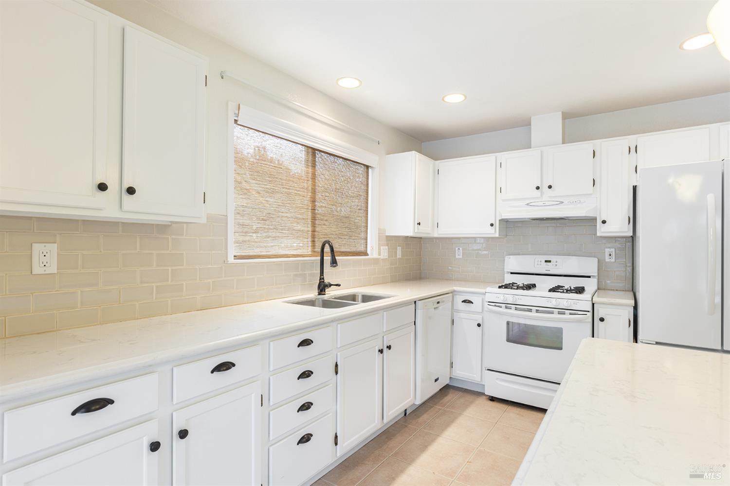 349 Sugar Maple Lane Windsor, CA 95492 - Photo 17 of 47 a kitchen with cabinets appliances a sink and a window