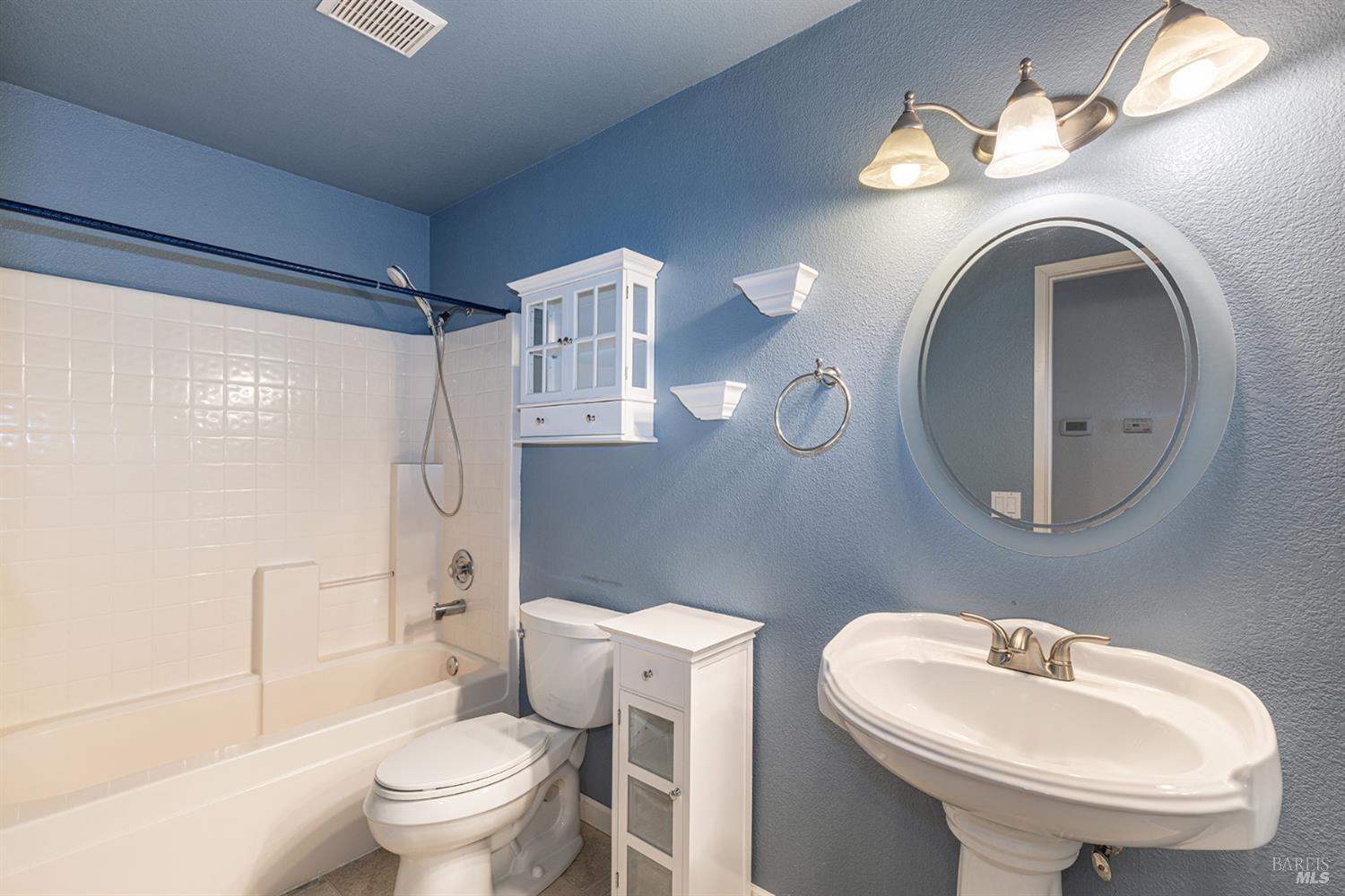 349 Sugar Maple Lane Windsor, CA 95492 - Photo 34 of 47 a bathroom with a sink a toilet and a mirror