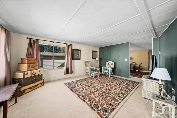 a bedroom with furniture and a flat screen tv