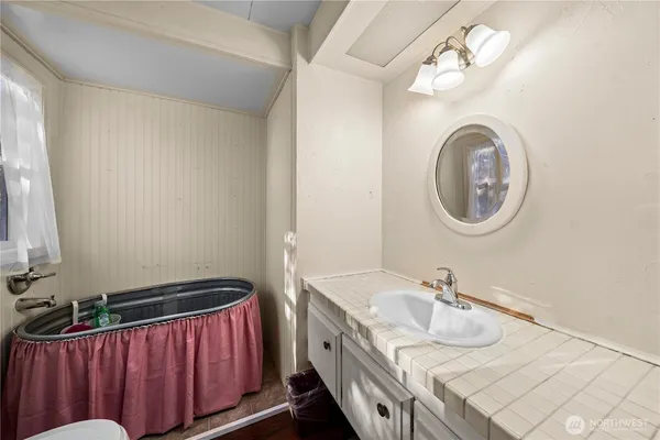 a view of a bedroom with furniture and windows