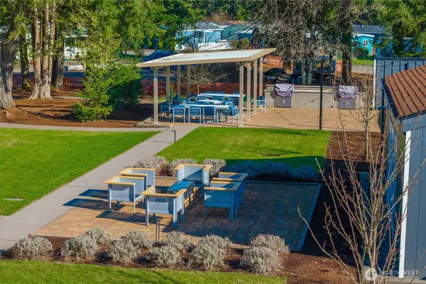 a view of a chairs and table in the patio and a yard
