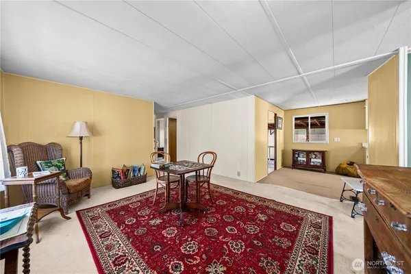 a living room with furniture rug and window