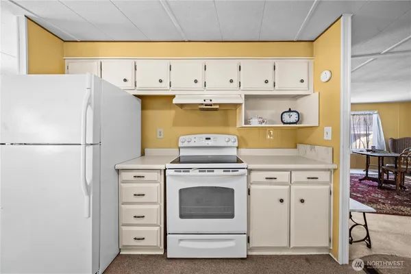 a kitchen with cabinets appliances and a counter space
