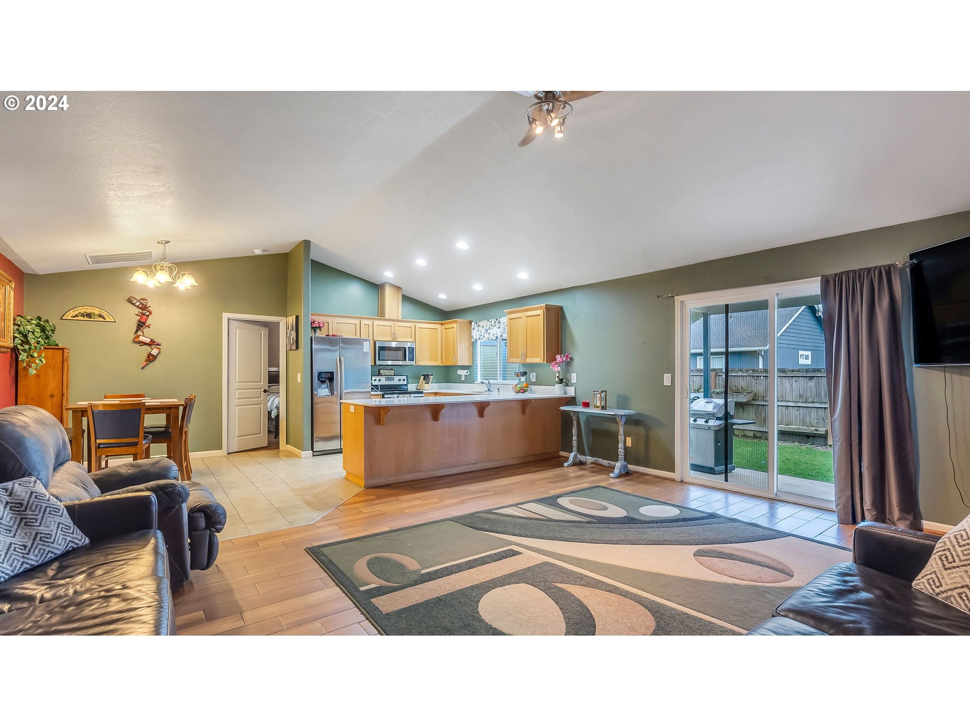 4688 Swegle Road Northeast Salem, OR 97301 - Photo 6 of 18 a living room with furniture a wooden floor and a large window