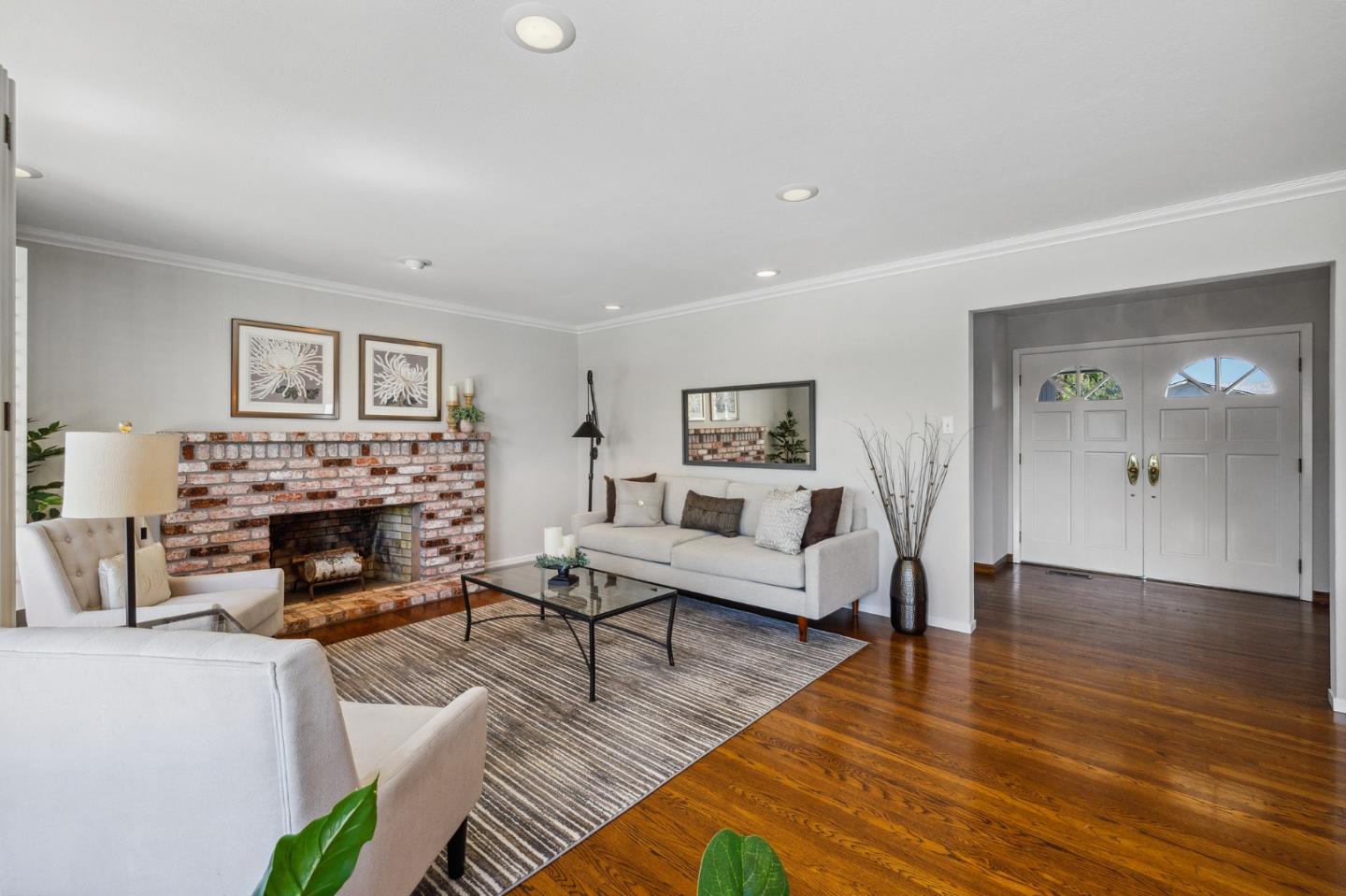 1245 Encina Drive Millbrae, CA 94030 - Photo 12 of 100 a living room with furniture a fireplace and a flat screen tv