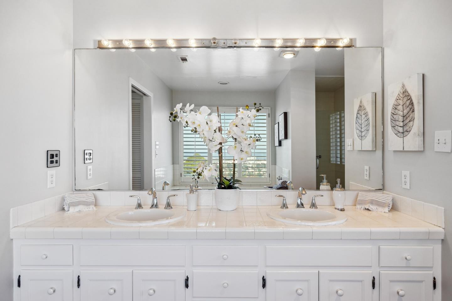 1245 Encina Drive Millbrae, CA 94030 - Photo 51 of 100 a bathroom with double vanity sinks and a mirror