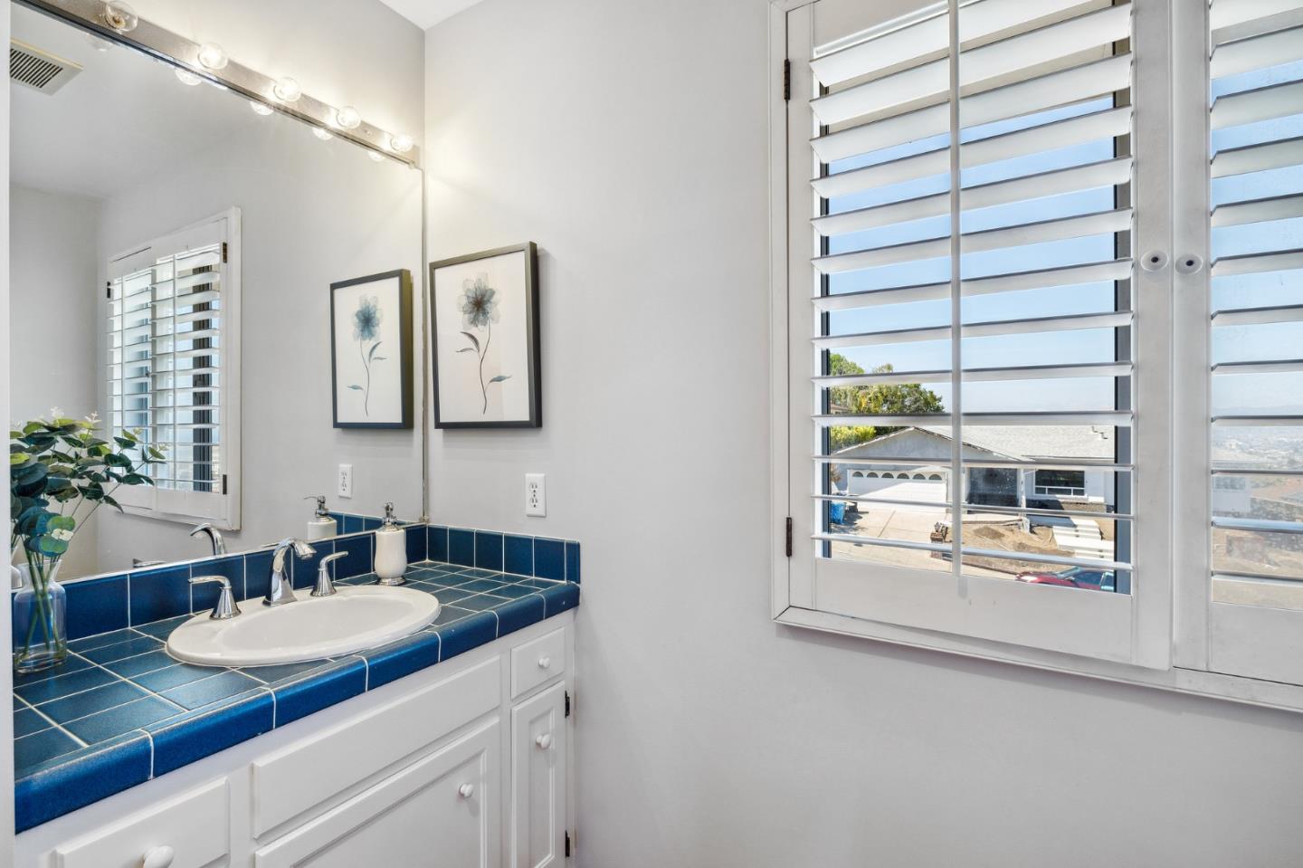 1245 Encina Drive Millbrae, CA 94030 - Photo 66 of 100 a bathroom with a granite countertop sink and a mirror