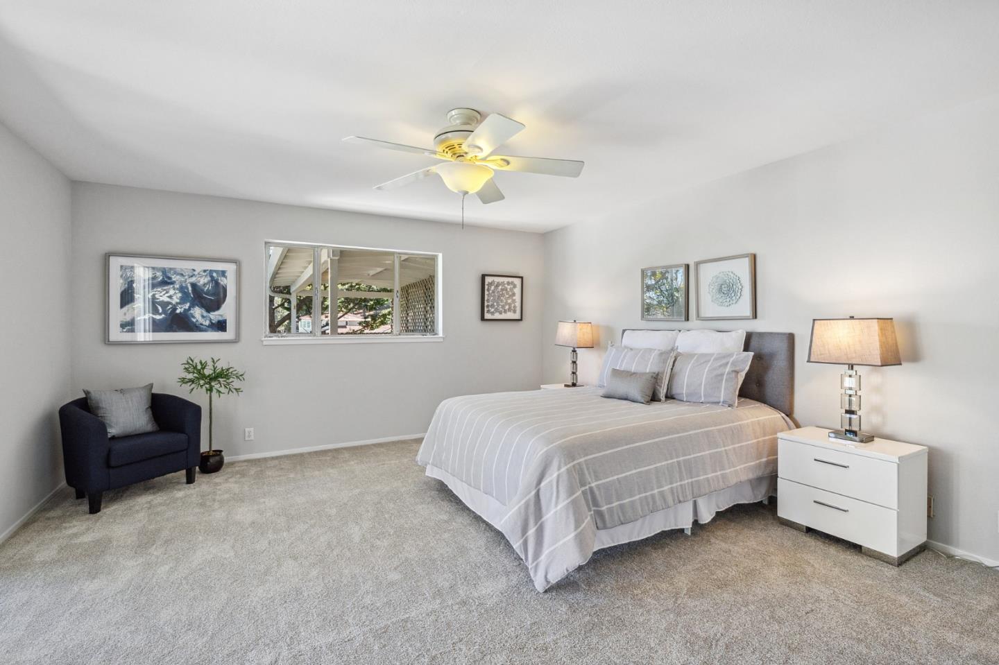 1245 Encina Drive Millbrae, CA 94030 - Photo 75 of 100 a bedroom with a bed and a chandelier