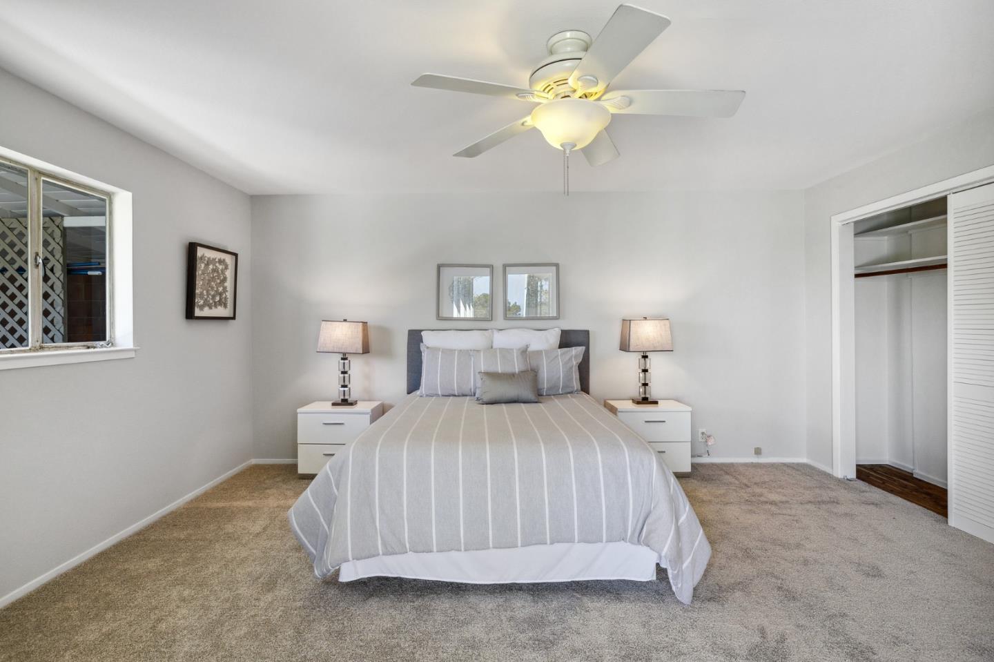 1245 Encina Drive Millbrae, CA 94030 - Photo 76 of 100 a bedroom with a bed and a chandelier