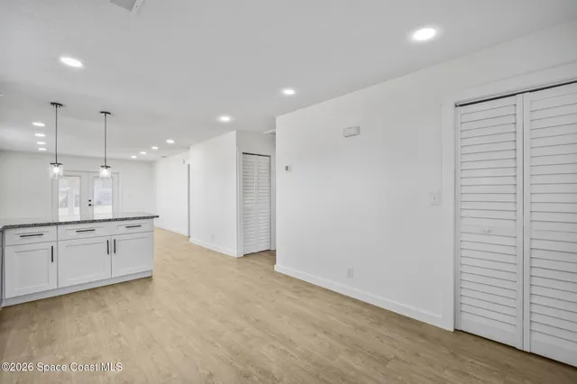 a view of a kitchen with a sink hardwood floor and a view of kitchen