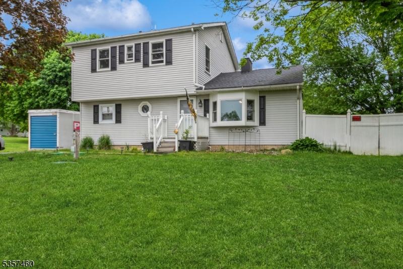 8 Millbrook Road Washington, NJ 07882 - Photo 1 of 24 a front view of a house with a garden and plants