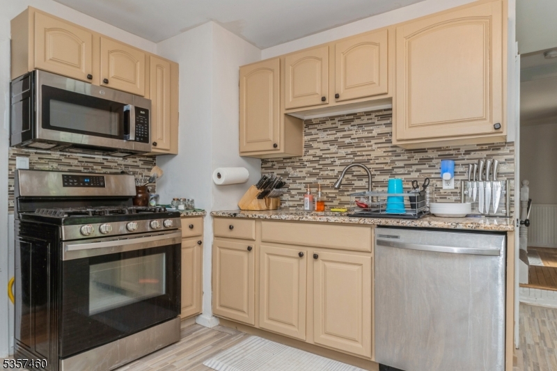 8 Millbrook Road Washington, NJ 07882 - Photo 6 of 24 a kitchen with white cabinets and stainless steel appliances