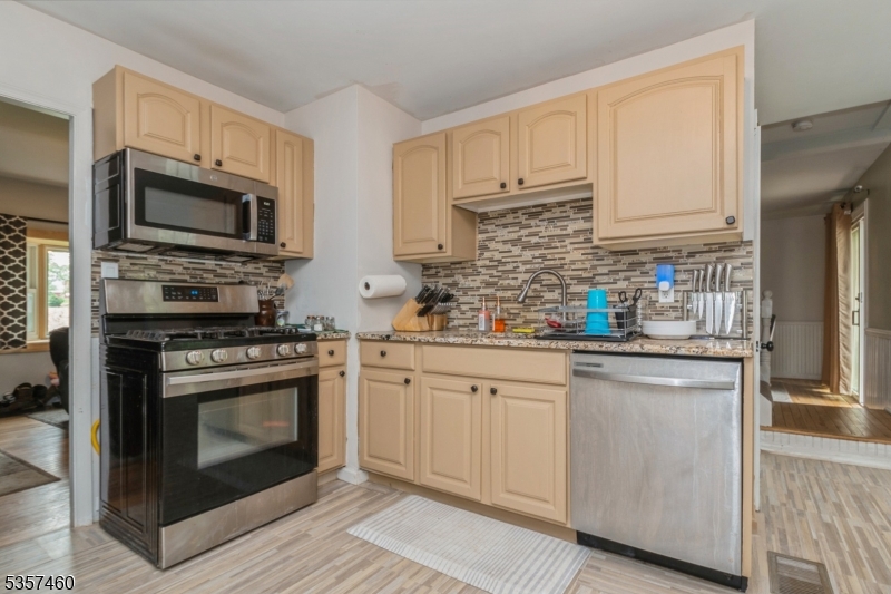 8 Millbrook Road Washington, NJ 07882 - Photo 7 of 24 a kitchen with stainless steel appliances granite countertop a stove a sink and a microwave