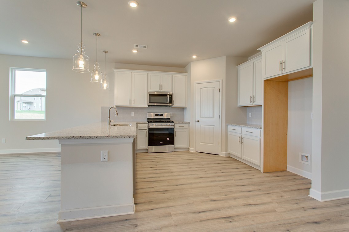1310 Kristopher Drive Lebanon, TN 37087 - Photo 12 of 36 a kitchen with kitchen island a sink stainless steel appliances and cabinets