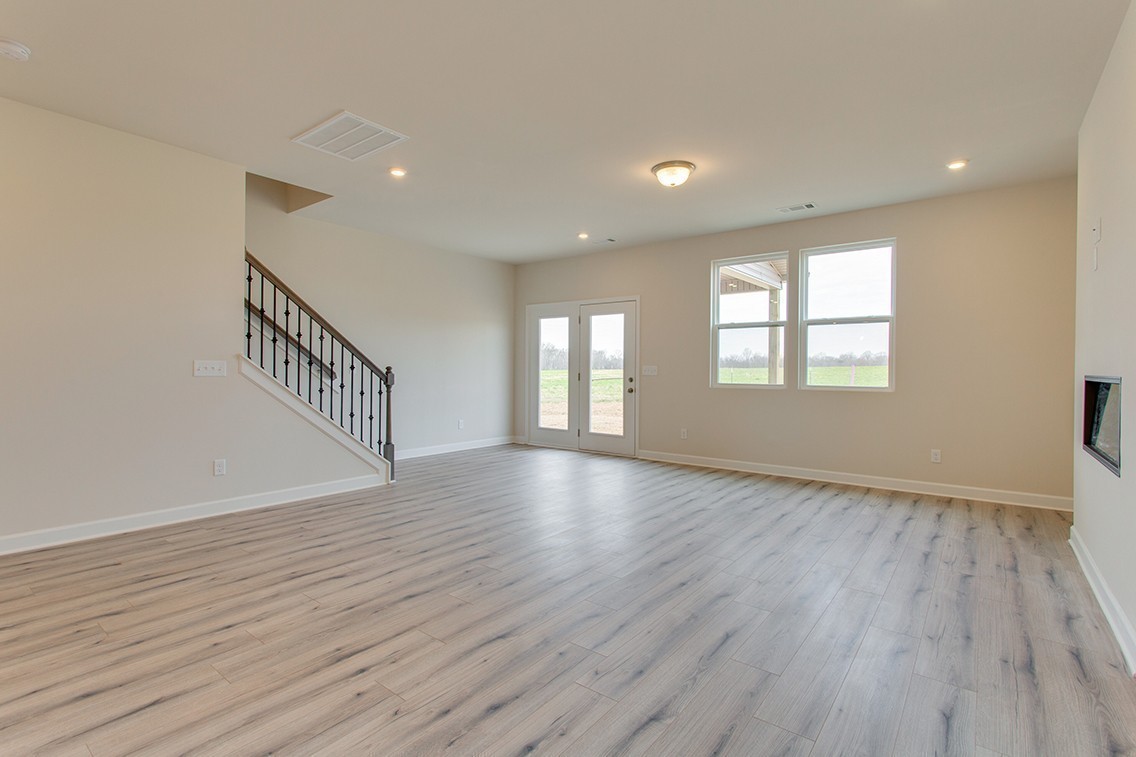 1310 Kristopher Drive Lebanon, TN 37087 - Photo 13 of 36 a view of an empty room with wooden floor and window