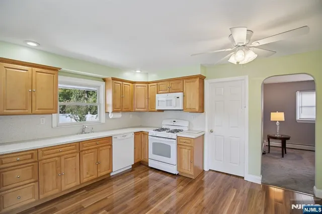 a kitchen with a sink cabinets and wooden floor