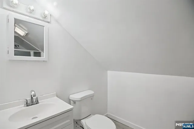 a white toilet sitting next to a bathroom sink