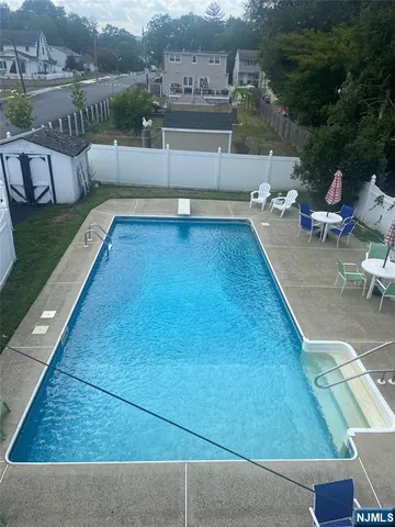 swimming pool view with a seating space
