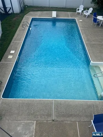 a view of a swimming pool and lounge chair