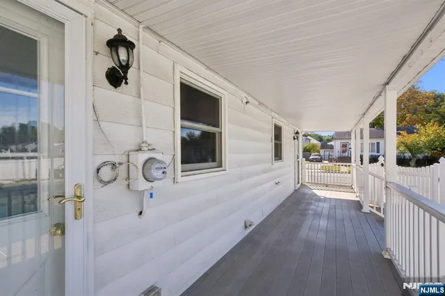 a view of a hallway to a house and wooden floor