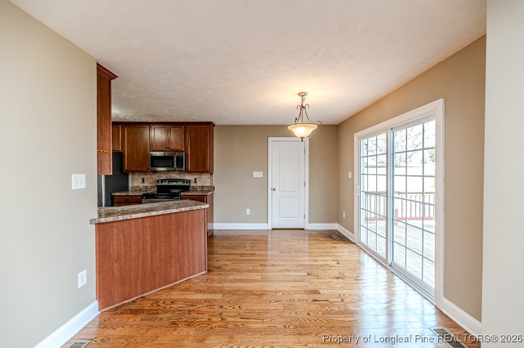 255 Trenton Place Cameron, NC 28326 - Photo 11 of 49 a large kitchen with stainless steel appliances granite countertop a stove a sink and a refrigerator