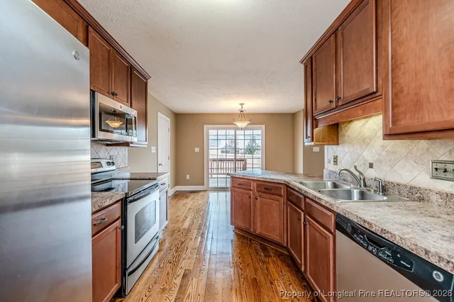 a kitchen with stainless steel appliances granite countertop a stove and cabinets