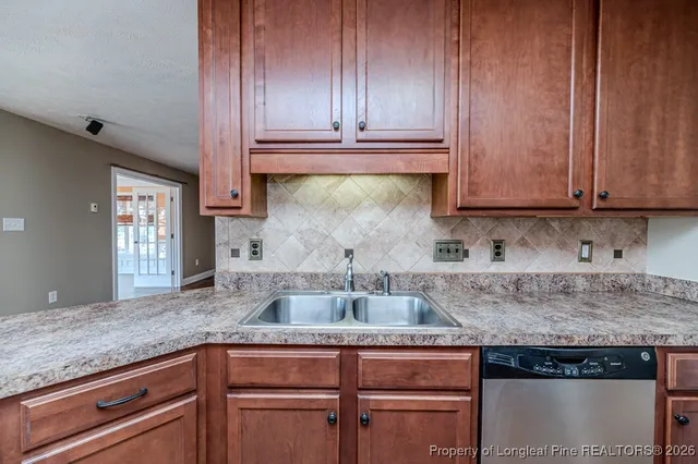 a kitchen with kitchen island granite countertop wooden cabinets and a counter top space