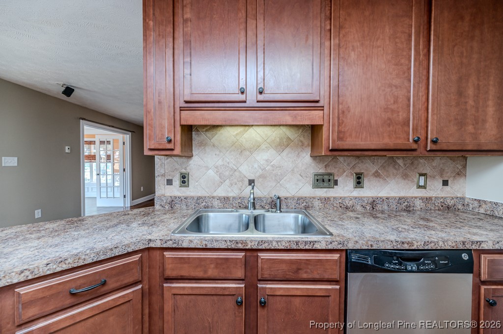 255 Trenton Place Cameron, NC 28326 - Photo 15 of 49 a kitchen with kitchen island granite countertop wooden cabinets and a counter top space