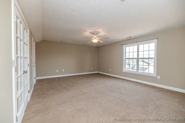 a view of a livingroom with a ceiling fan and window