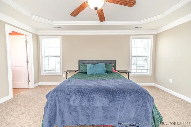 a large bed sitting in a bedroom next to a window