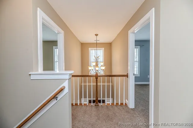a view of a hallway with windows and stairs