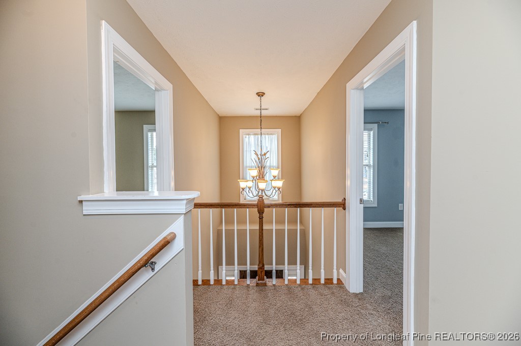 255 Trenton Place Cameron, NC 28326 - Photo 31 of 49 a view of a hallway with windows and stairs