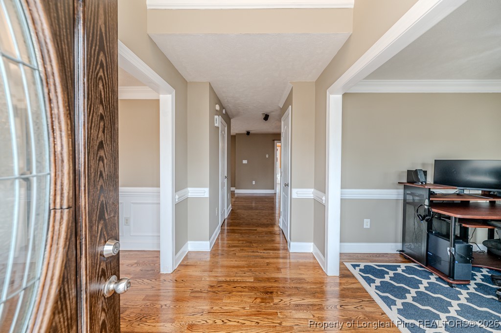 255 Trenton Place Cameron, NC 28326 - Photo 4 of 49 a view of a hallway with workspace and wooden floor