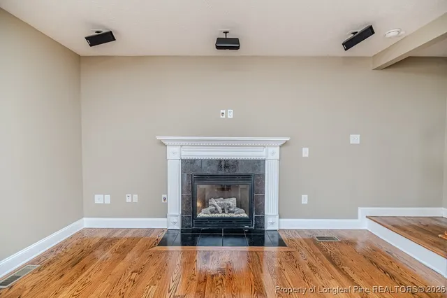 a living room with a fireplace and a fireplace