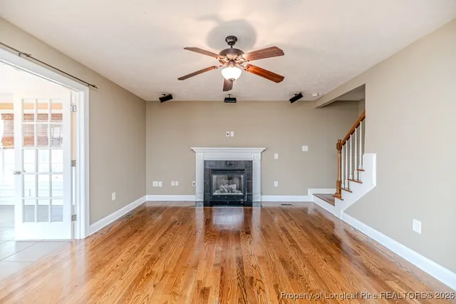 a view of an empty room window and wooden floor