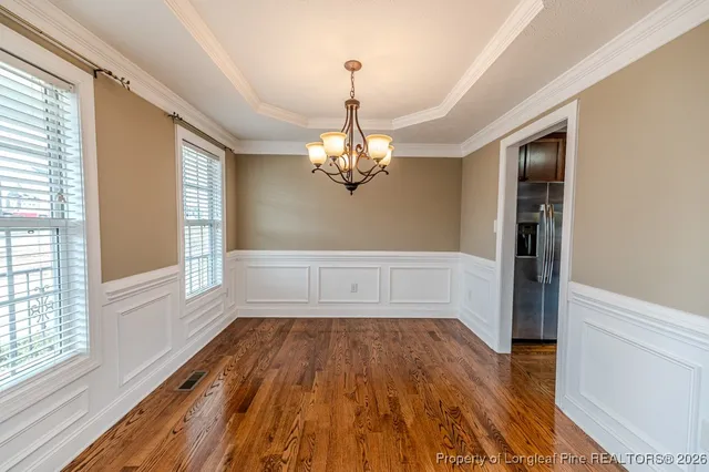 a view of a livingroom with wooden floor and a window