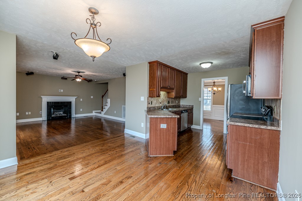 255 Trenton Place Cameron, NC 28326 - Photo 7 of 49 a kitchen with stainless steel appliances granite countertop a stove refrigerator and a sink