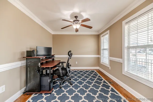 a view of a workspace with furniture and a window
