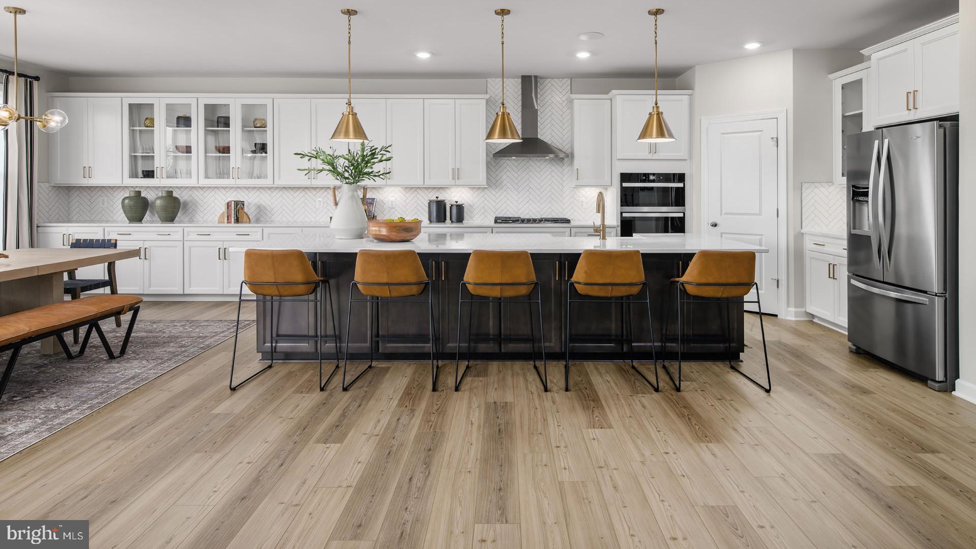 6 Northern Vw Road Culpeper, VA 22701 - Photo 4 of 44 a kitchen with stainless steel appliances granite countertop a refrigerator a stove a sink and a dining table with wooden floor