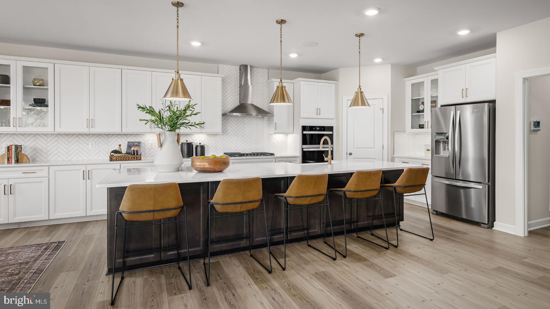 6 Northern Vw Road Culpeper, VA 22701 - Photo 5 of 44 a kitchen with granite countertop a refrigerator a stove a sink and white cabinets with wooden floor