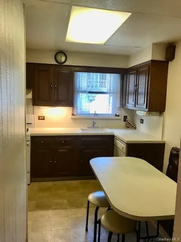 a kitchen with a table chairs sink and cabinets