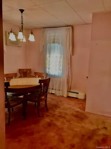 a view of a dining room with furniture and chandelier