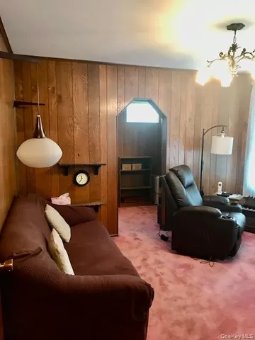 a living room with furniture and a mirror