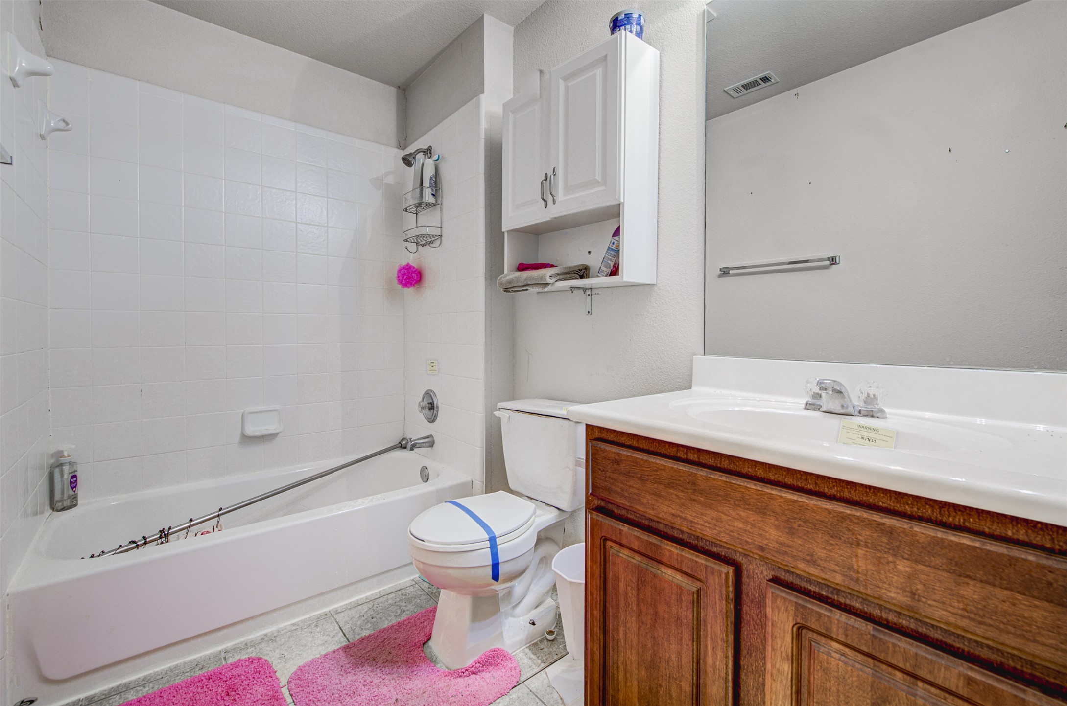 2090 Intrepid Drive Buda, TX 78610 - Photo 15 of 24 Bathroom with vanity, light tile patterned floors, and bathtub / shower combination