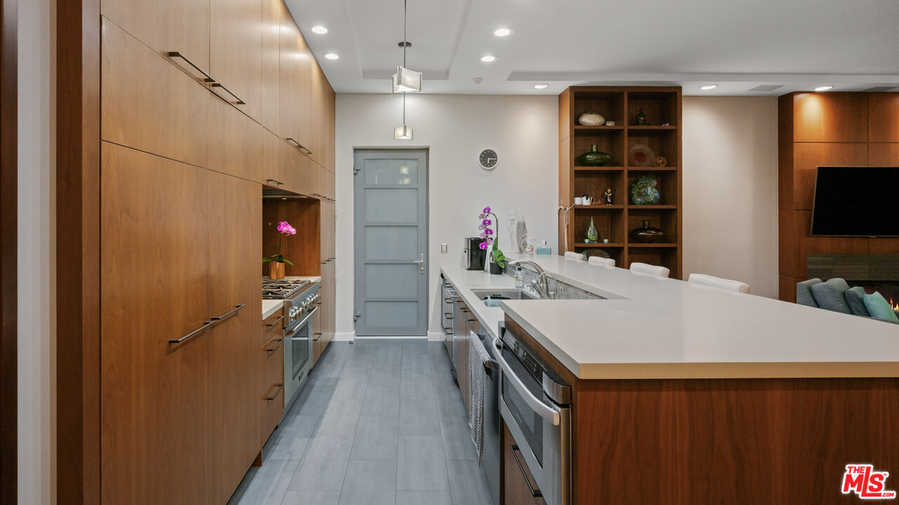 7350 Rindge Avenue Playa del Rey, CA 90293 - Photo 18 of 55 a kitchen that has a lot of cabinets a sink and a wooden floor