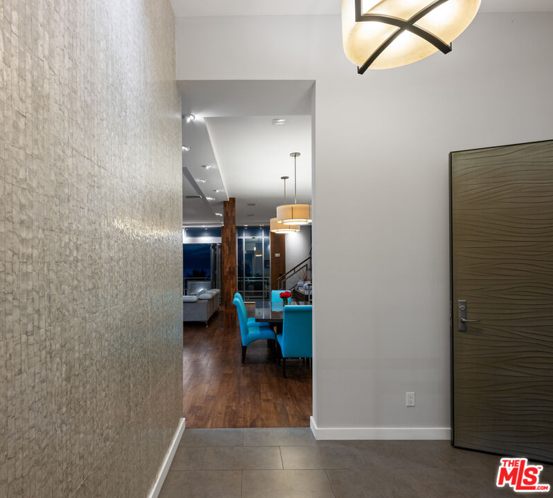7350 Rindge Avenue Playa del Rey, CA 90293 - Photo 6 of 55 a view of a hallway with wooden floor and a bathroom