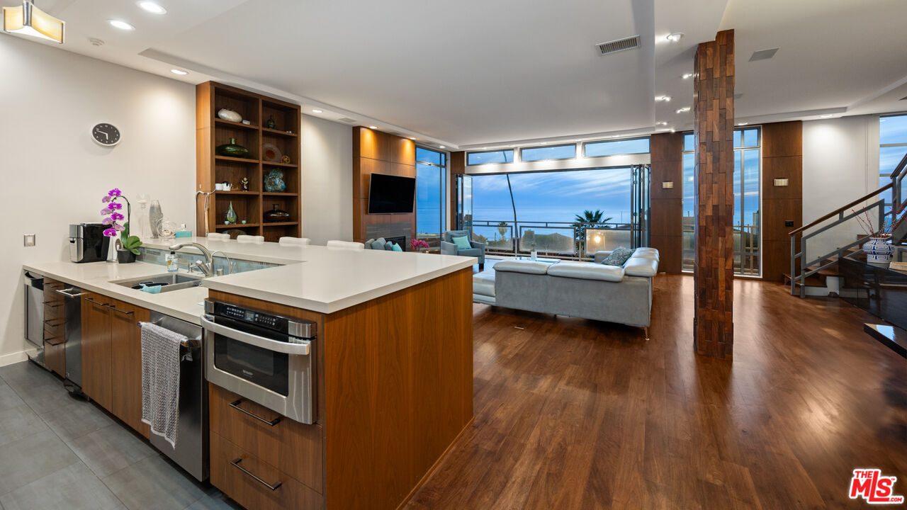 7350 Rindge Avenue Playa del Rey, CA 90293 - Photo 7 of 55 a open kitchen with stainless steel appliances granite countertop a stove and a refrigerator