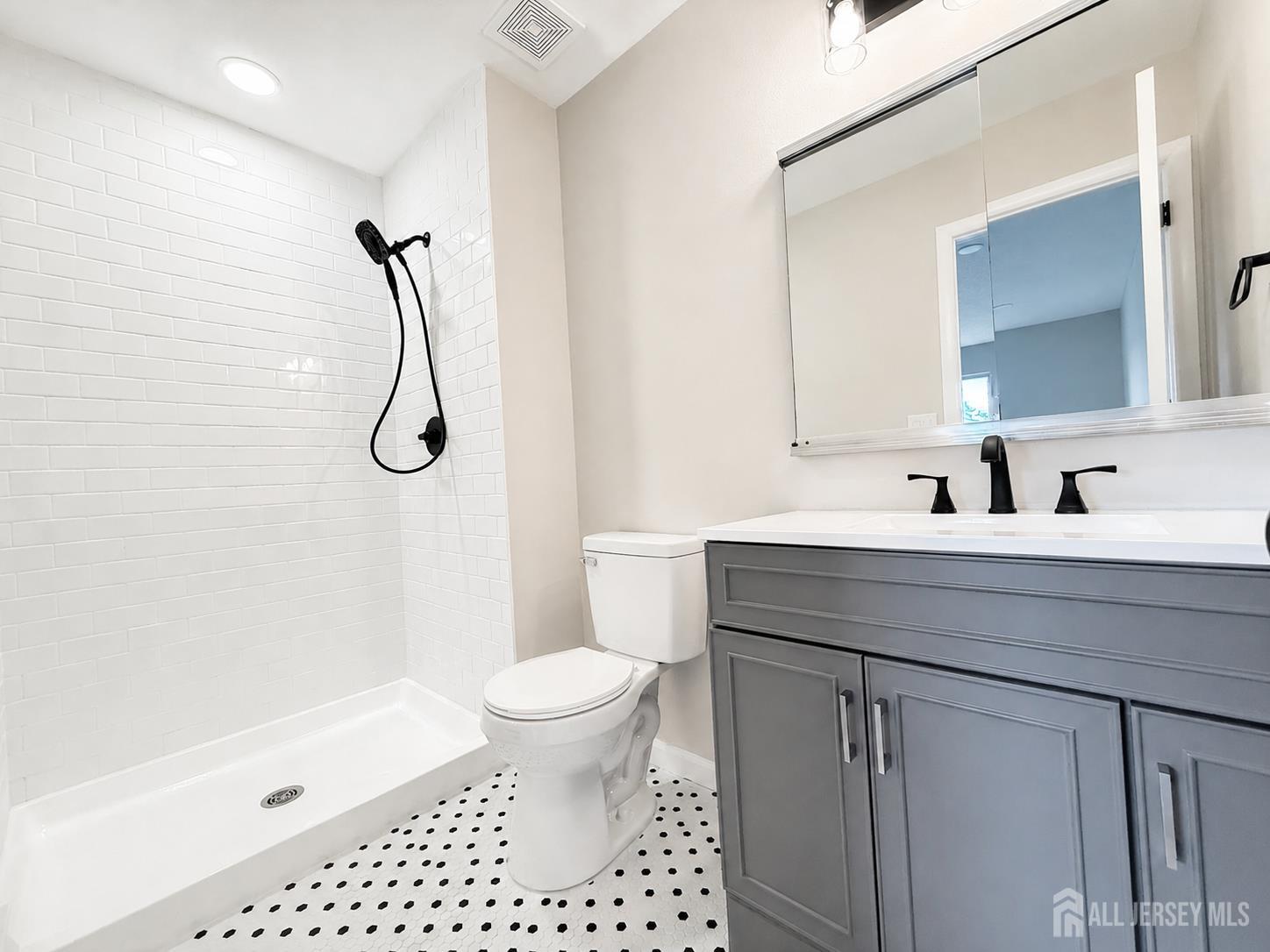 621 A Deal Road Monroe Township, NJ 08831 - Photo 20 of 27 a bathroom with a sink a toilet a mirror and shower