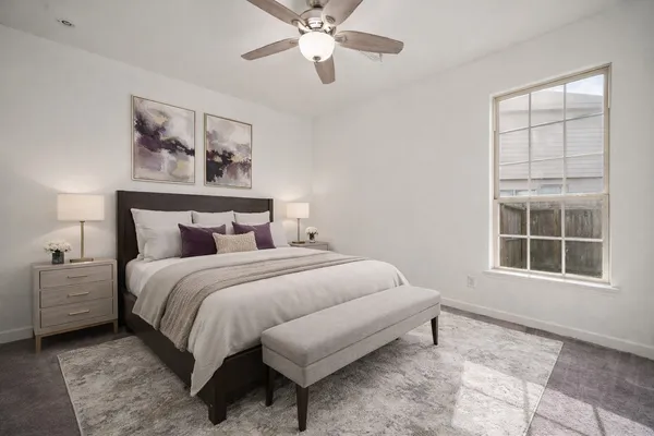 a bedroom with a bed and a window