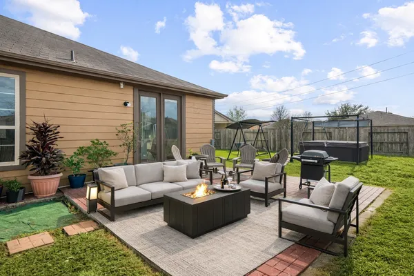 a view of a patio with couches and a fire pit